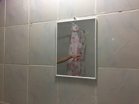 After picture showing sparkling tiles and mirror in the same bathroom.