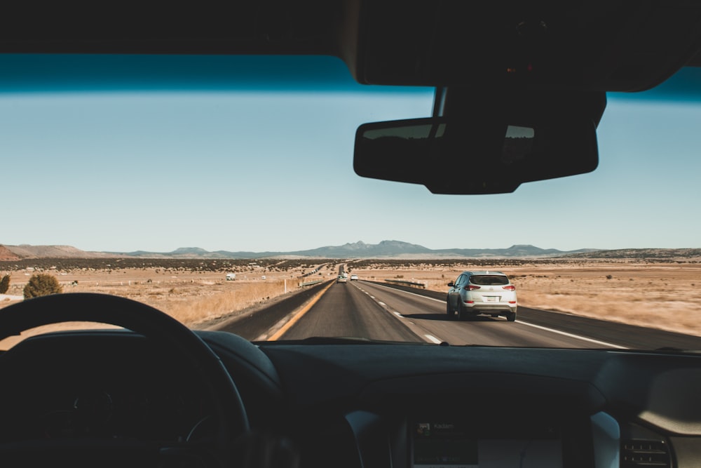 running vehicles on road during daytime