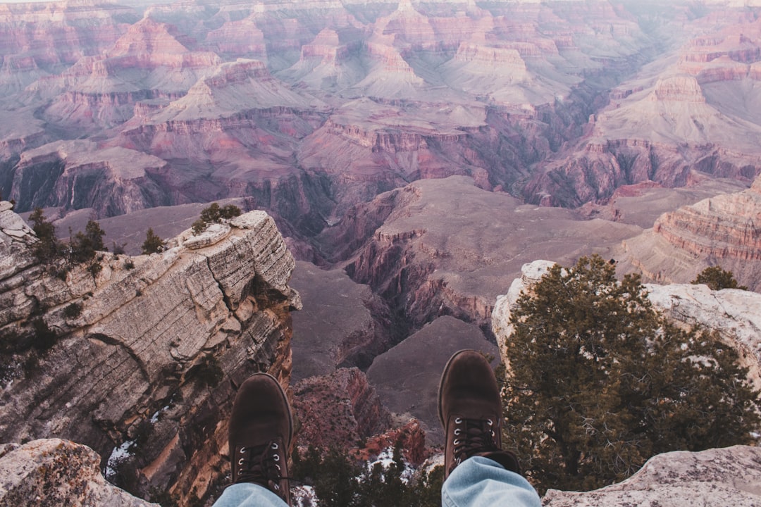 person sitting on cliff