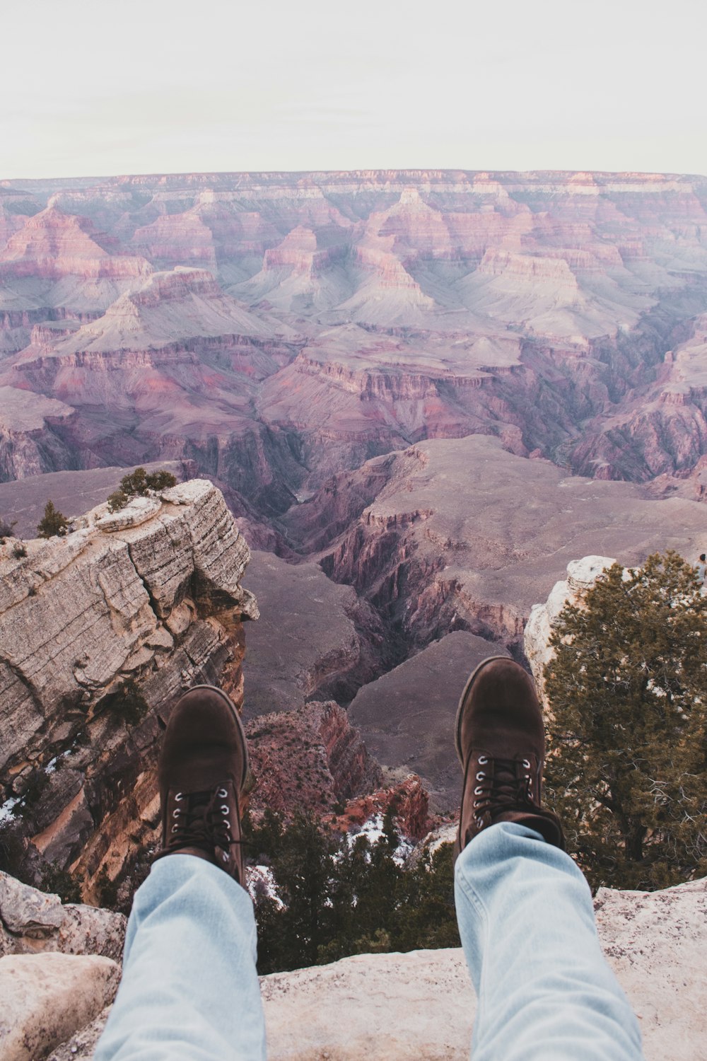 person sitting on cliff