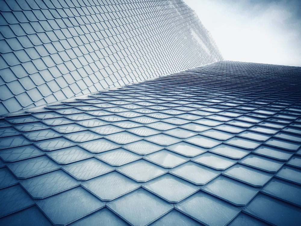 worm view photo of blue building under cloudy sky