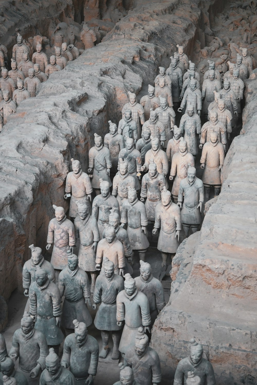 a group of statues of men standing next to each other