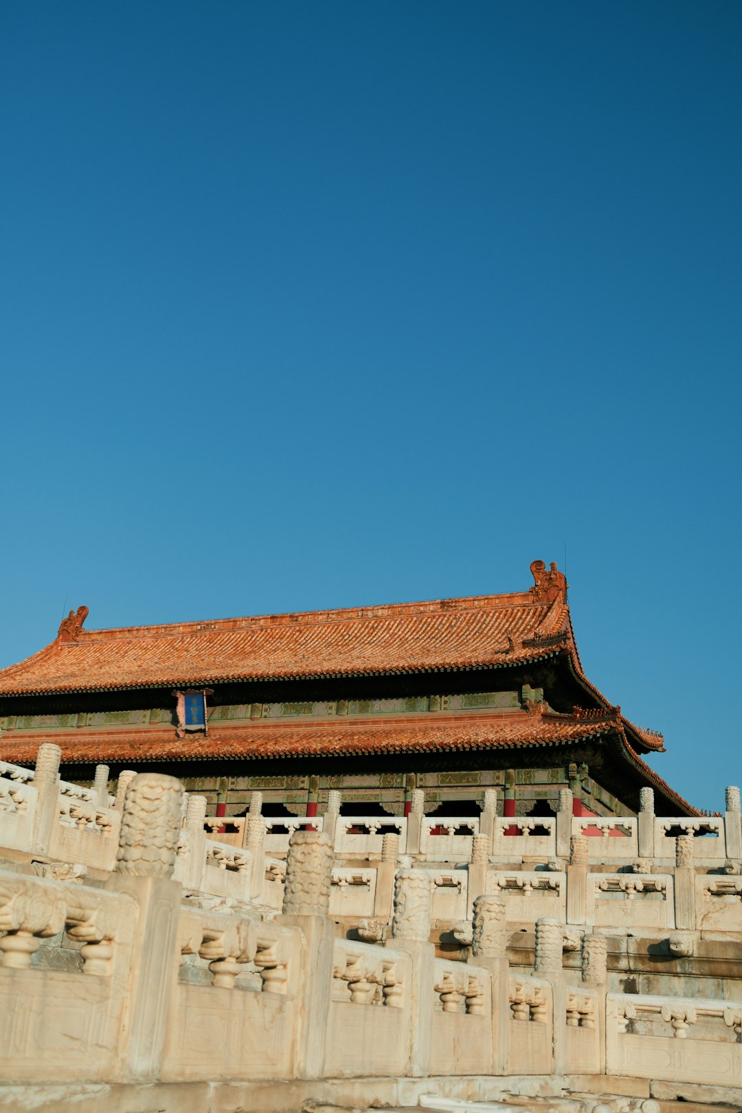 brown and green pagoda house under a calm blue sky