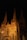 A Gothic-style cathedral with two prominent spires illuminated at night, showcasing intricate architectural details and a banner promoting refugee support hanging on the facade.