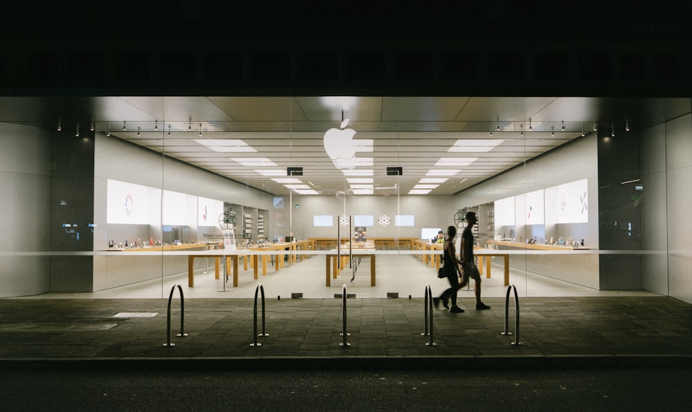 man and woman passing by store