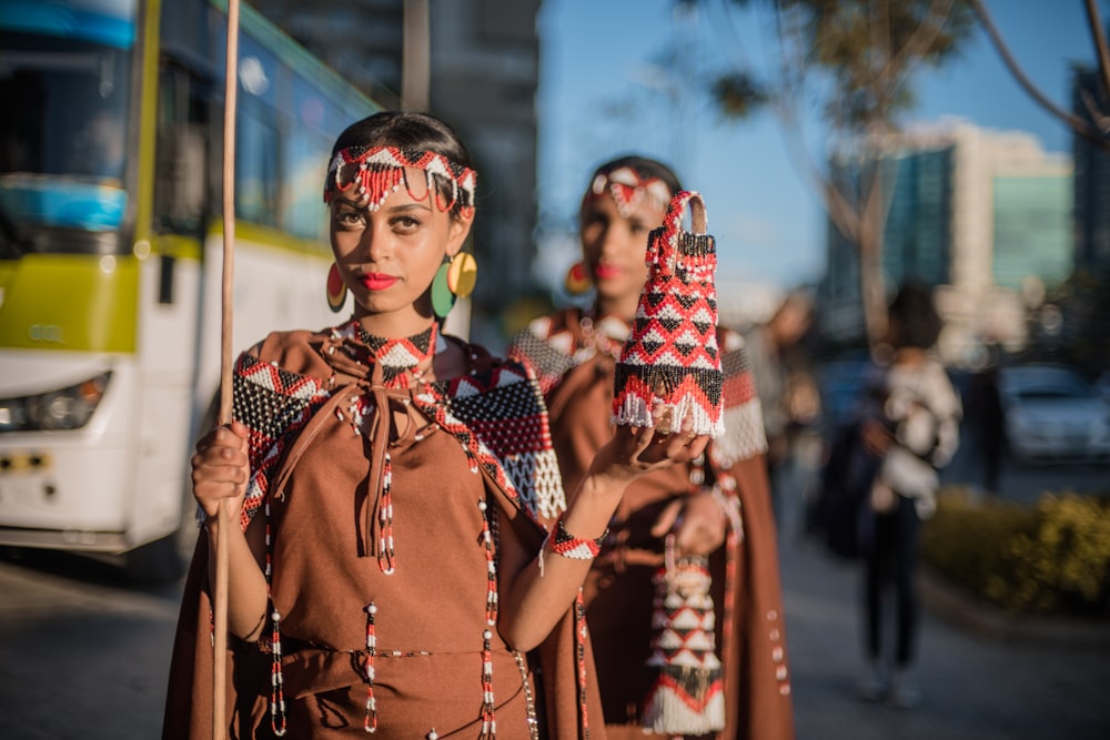 women standing beside bus