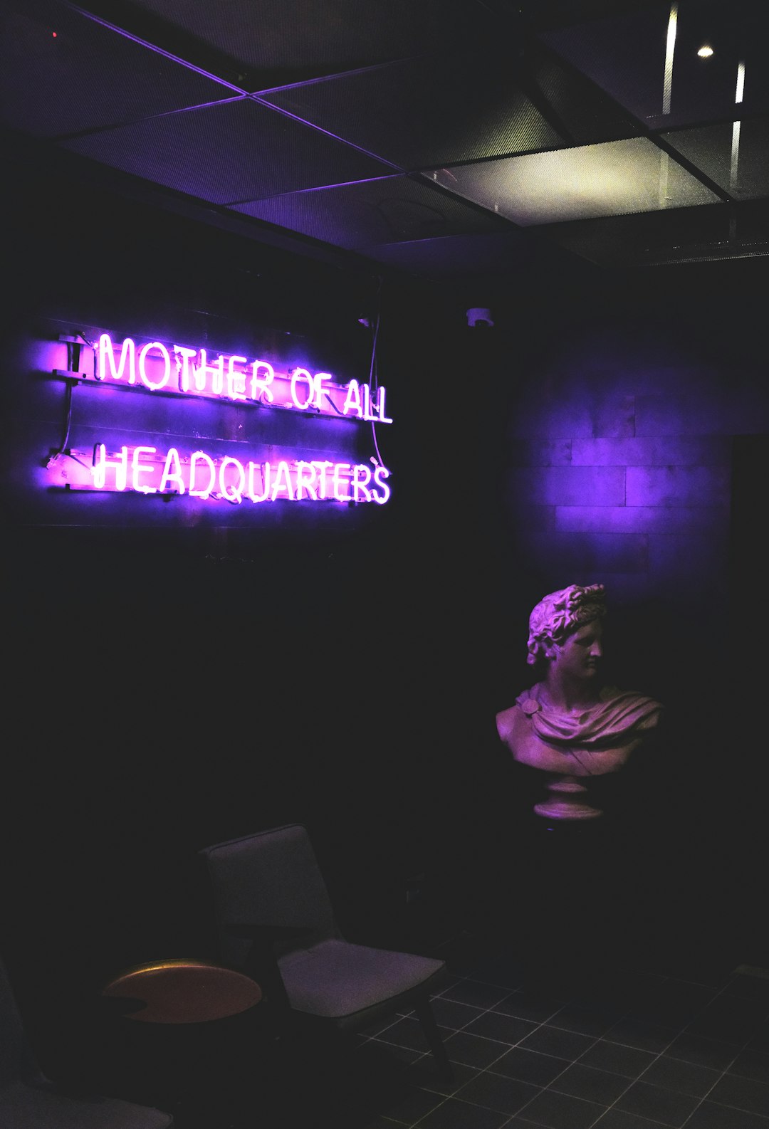 bust statue beside neon light signage