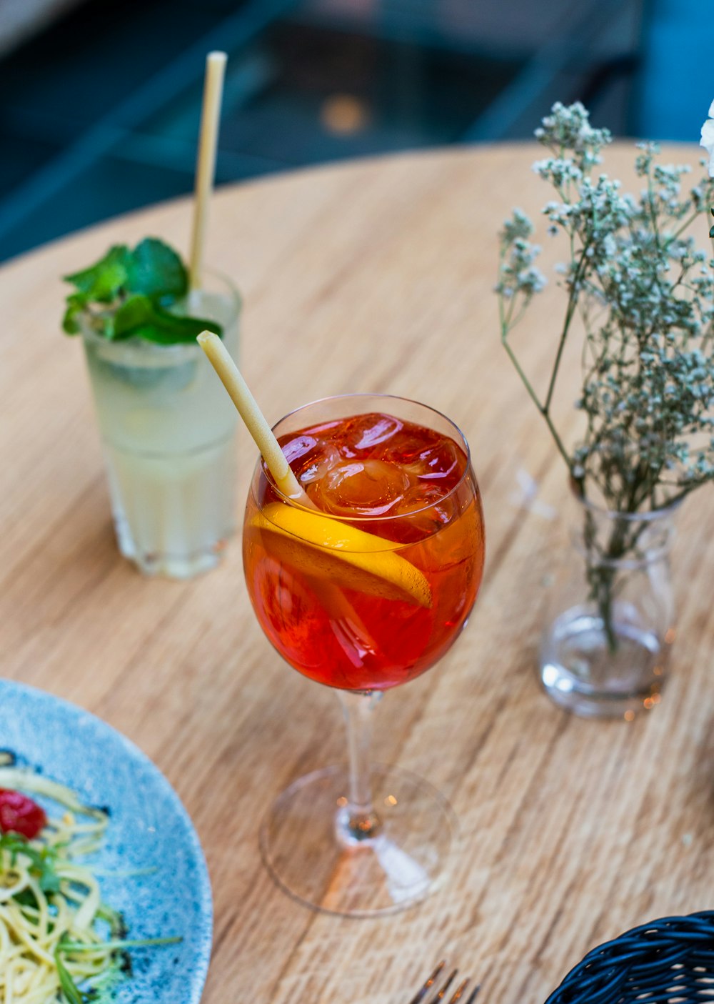 two drinks beside plant in vase