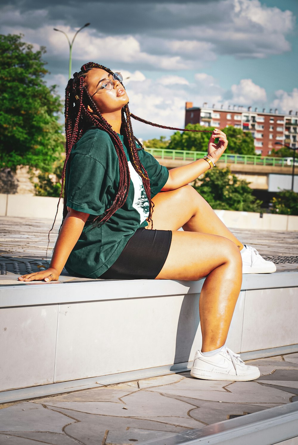 woman sitting on concrete surface