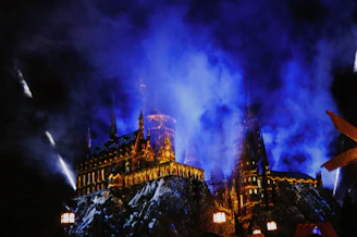 An intricate fantasy book cover showcasing a castle under a starry sky with swirling magical lights.