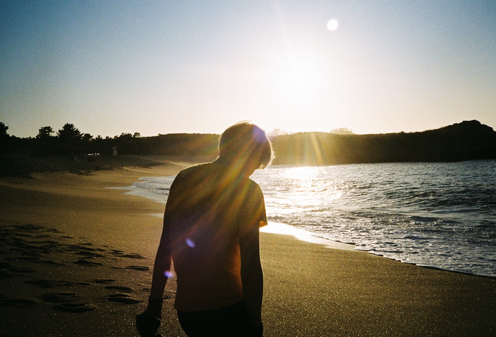 silhouette of person on seashore during daytime