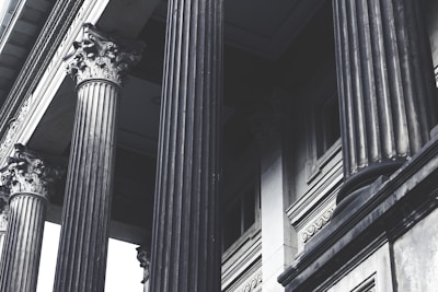 grayscale photo of concrete pillars