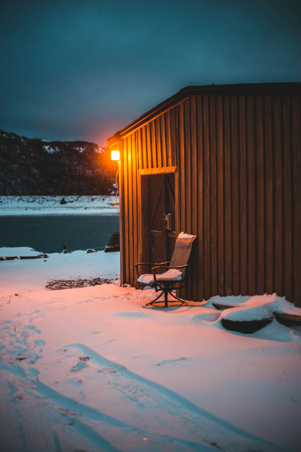 brown armchair beside brown wooden house