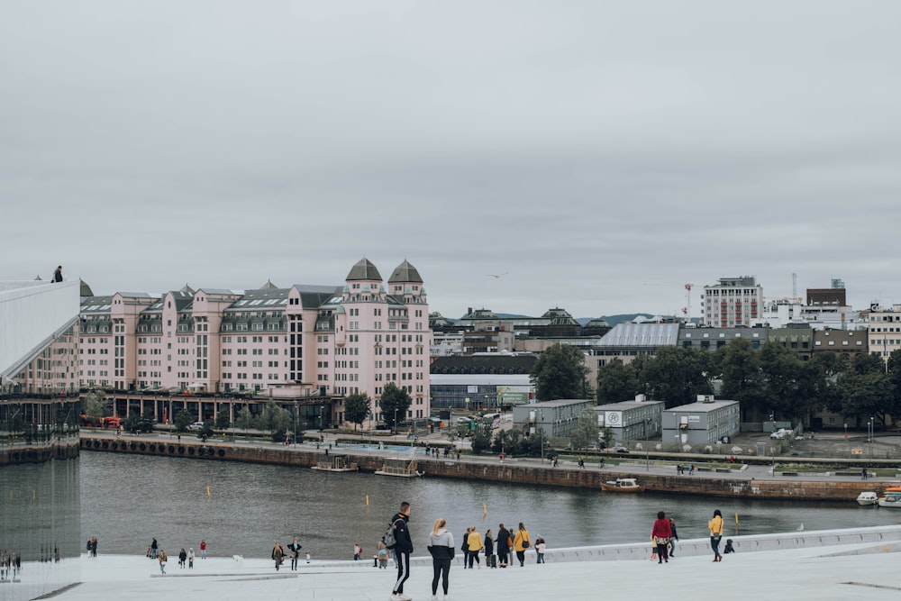 photography of people near outdoor beside body of water during daytime