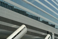 Commercial building 3D visualization with glass facades and urban environment.