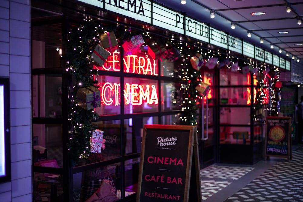 a restaurant with a neon sign in front of it