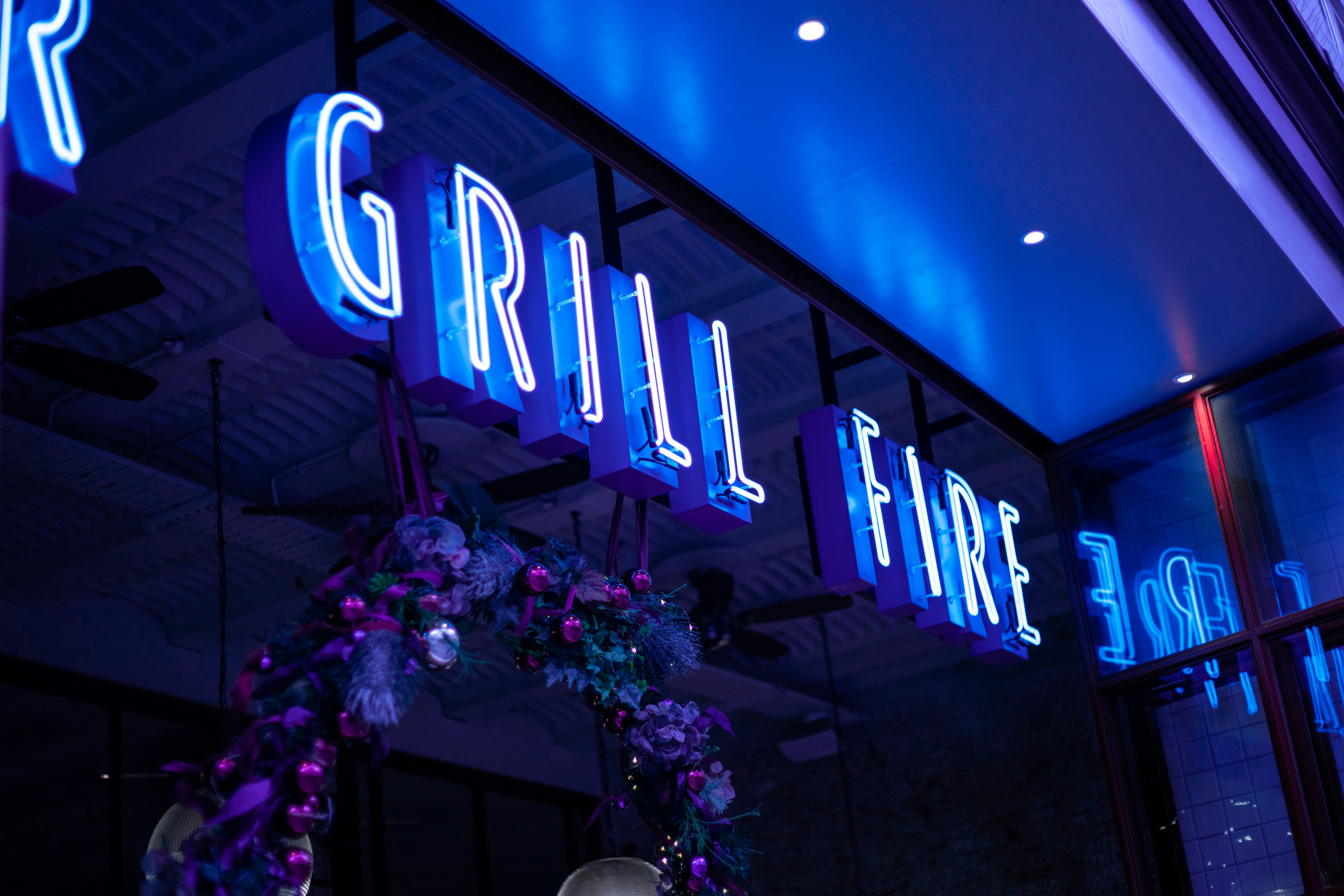 Illuminated neon channel letter sign — vibrant blue glow custom sign manufactured in Las Vegas