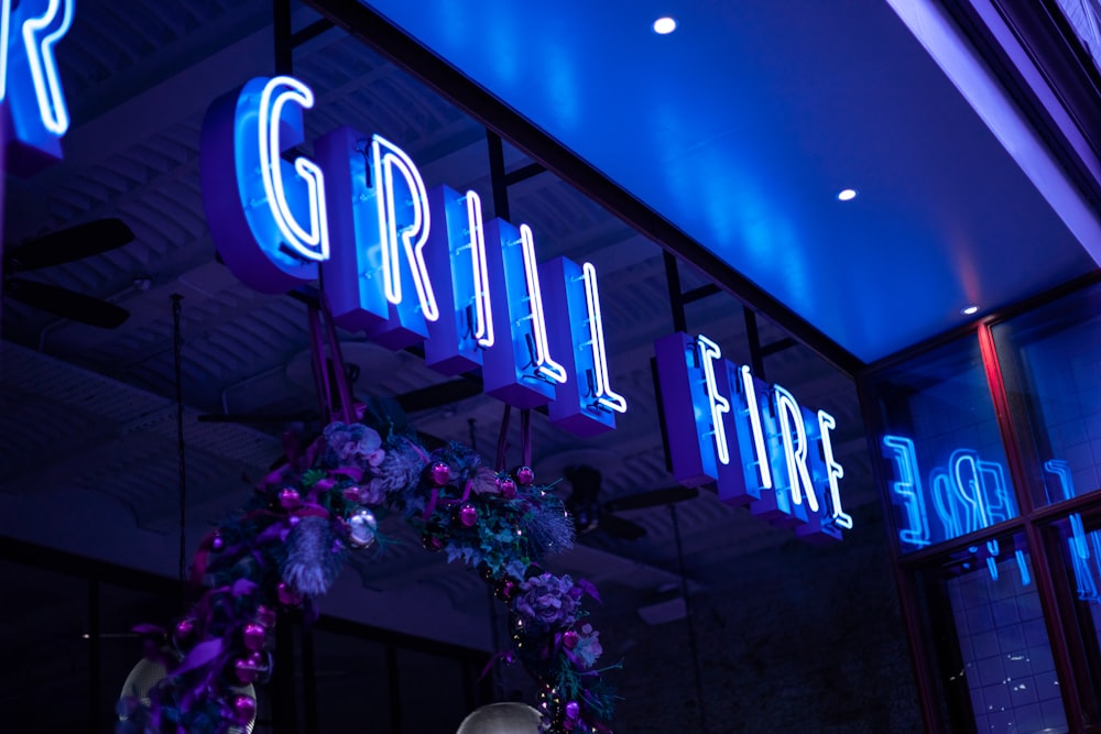 a blue neon sign that reads grill fine