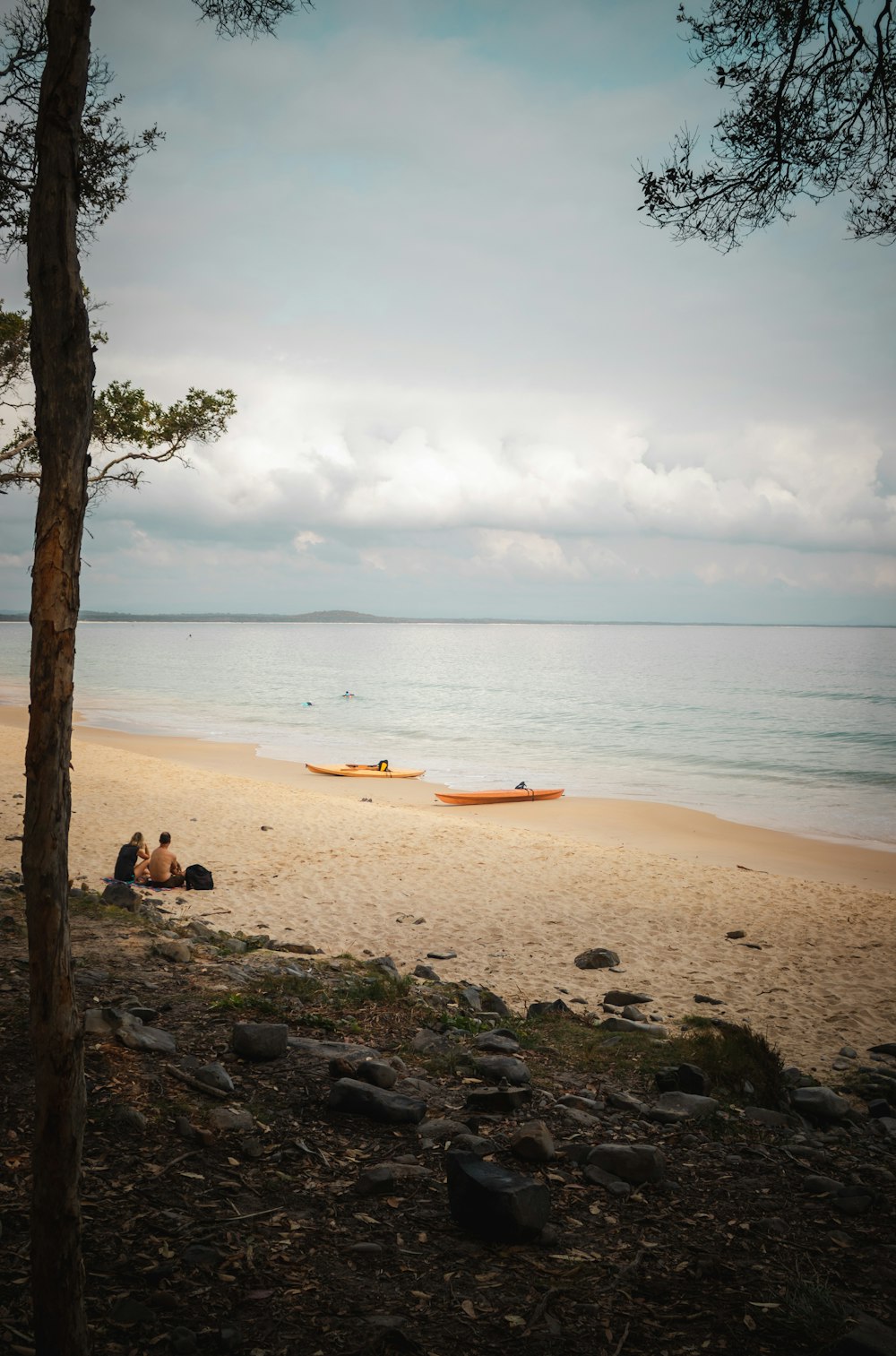 orange boat on seashore