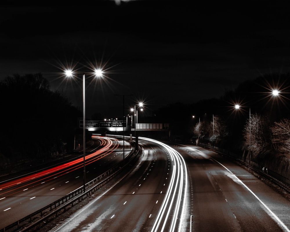 concrete road between lights in timelapse photo