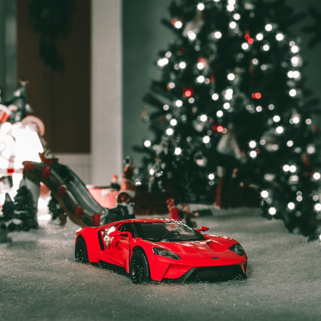 shallow focus photo of red sports car die-cast model