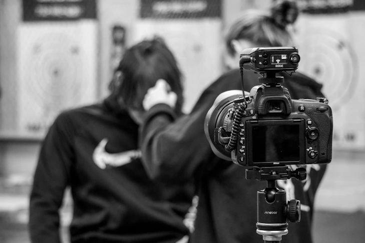 A professional video camera in grayscale, symbolising video production and content creation.