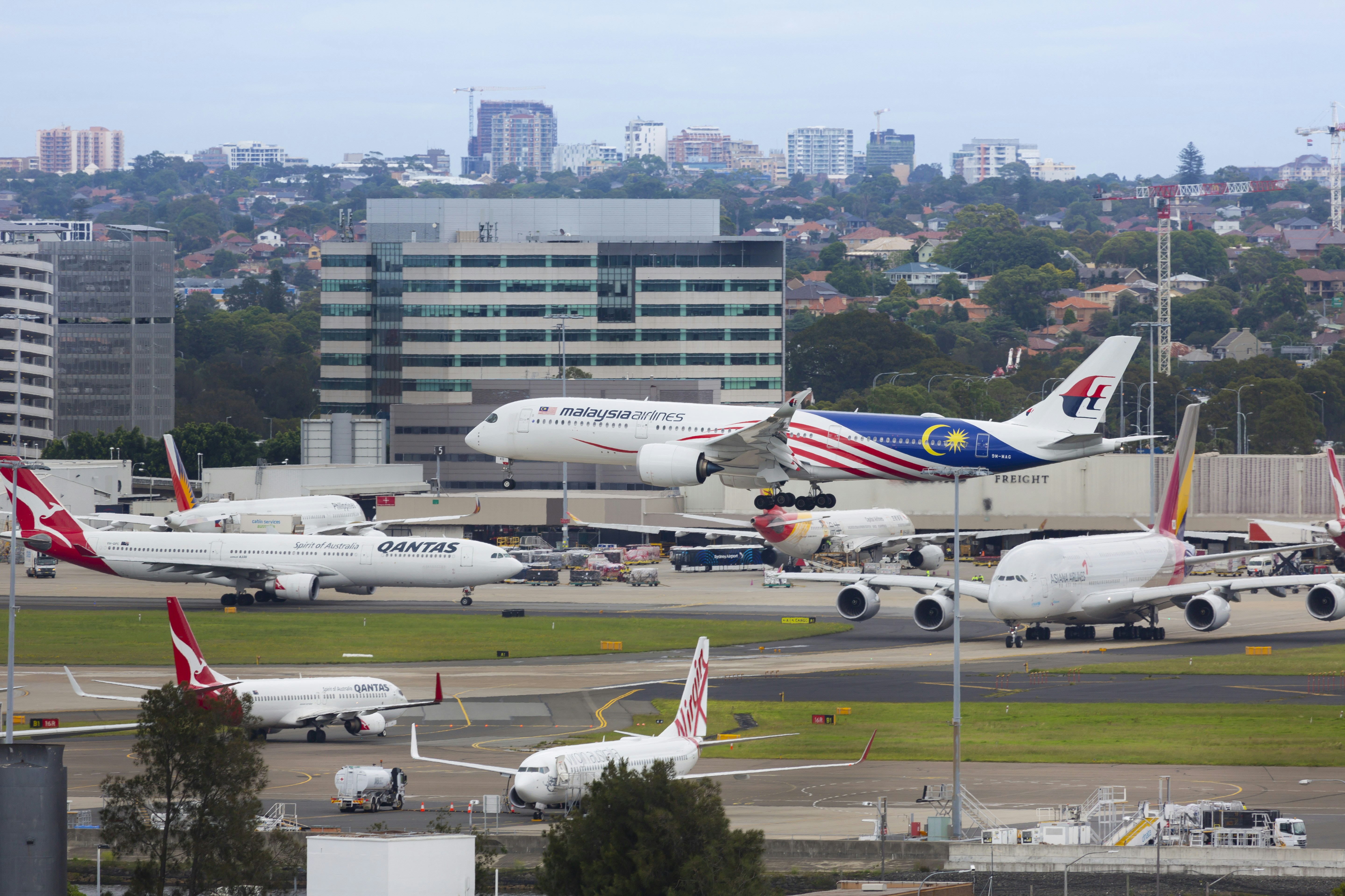 airplanes at airport, Malaysia Airlines landing at Sydney Airport.