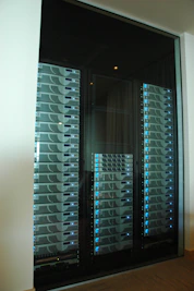 Server racks with blinking lights in a climate-controlled data center.