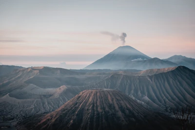 Dramatic volcanic landscape with clouds rolling over rugged peaks