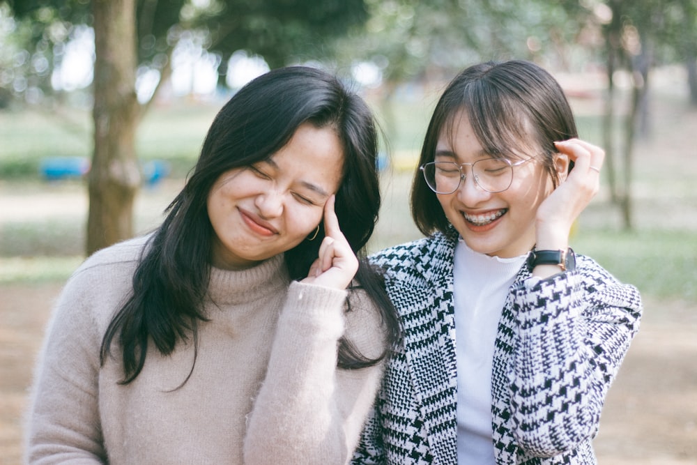 two women wearing sweaters smiling
