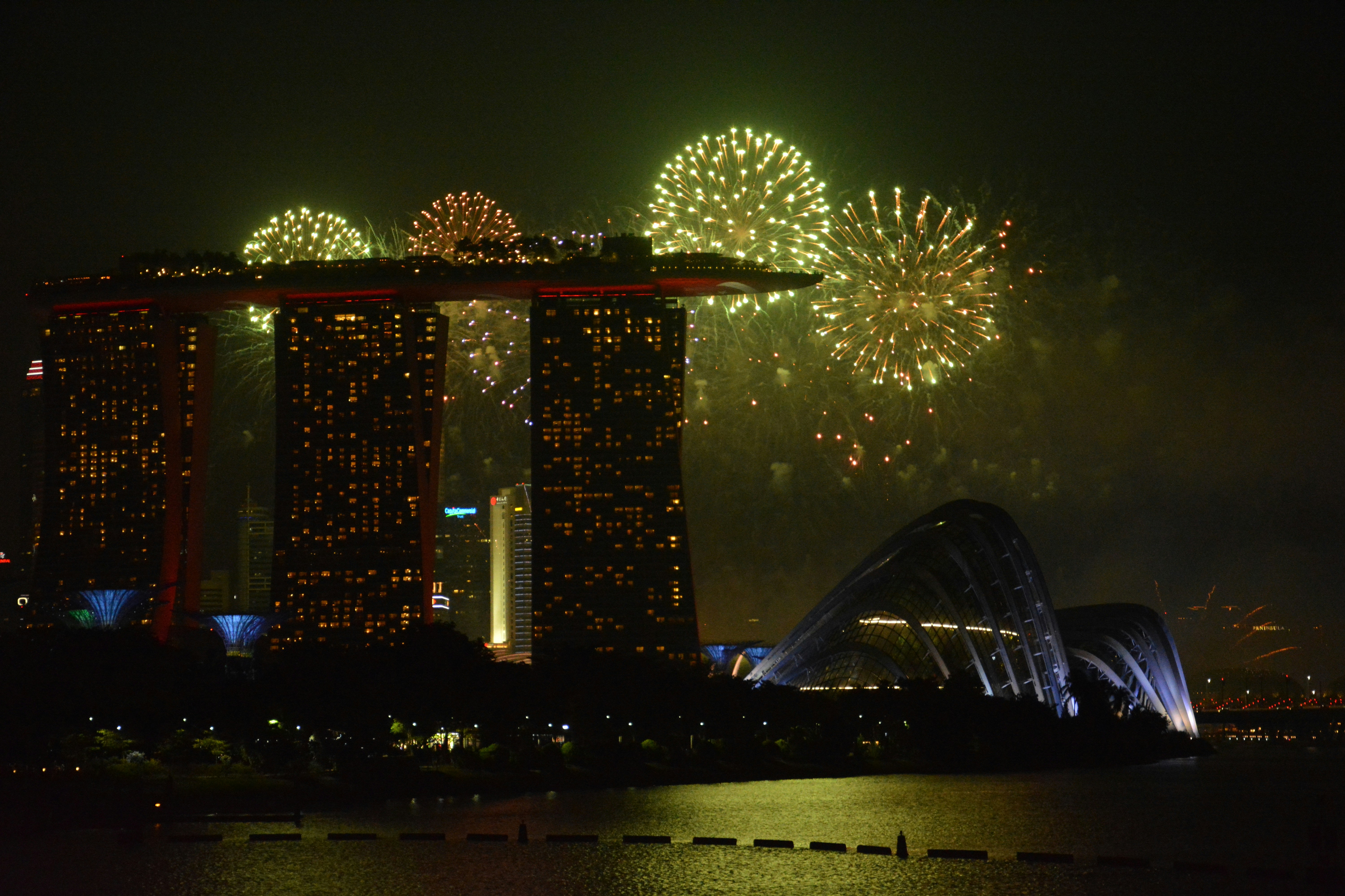 Fireworks Display Over City Buildings During Night Time Photo Free Image On Unsplash