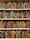 A bookshelf filled with books covered in vibrant, multicolored patterns. The patterns are diverse, featuring geometric shapes, swirling designs, and intricate motifs. The use of bright colors like red, blue, green, orange, and more gives each book a unique, artistic appearance.