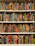 A bookshelf filled with books covered in vibrant, multicolored patterns. The patterns are diverse, featuring geometric shapes, swirling designs, and intricate motifs. The use of bright colors like red, blue, green, orange, and more gives each book a unique, artistic appearance.