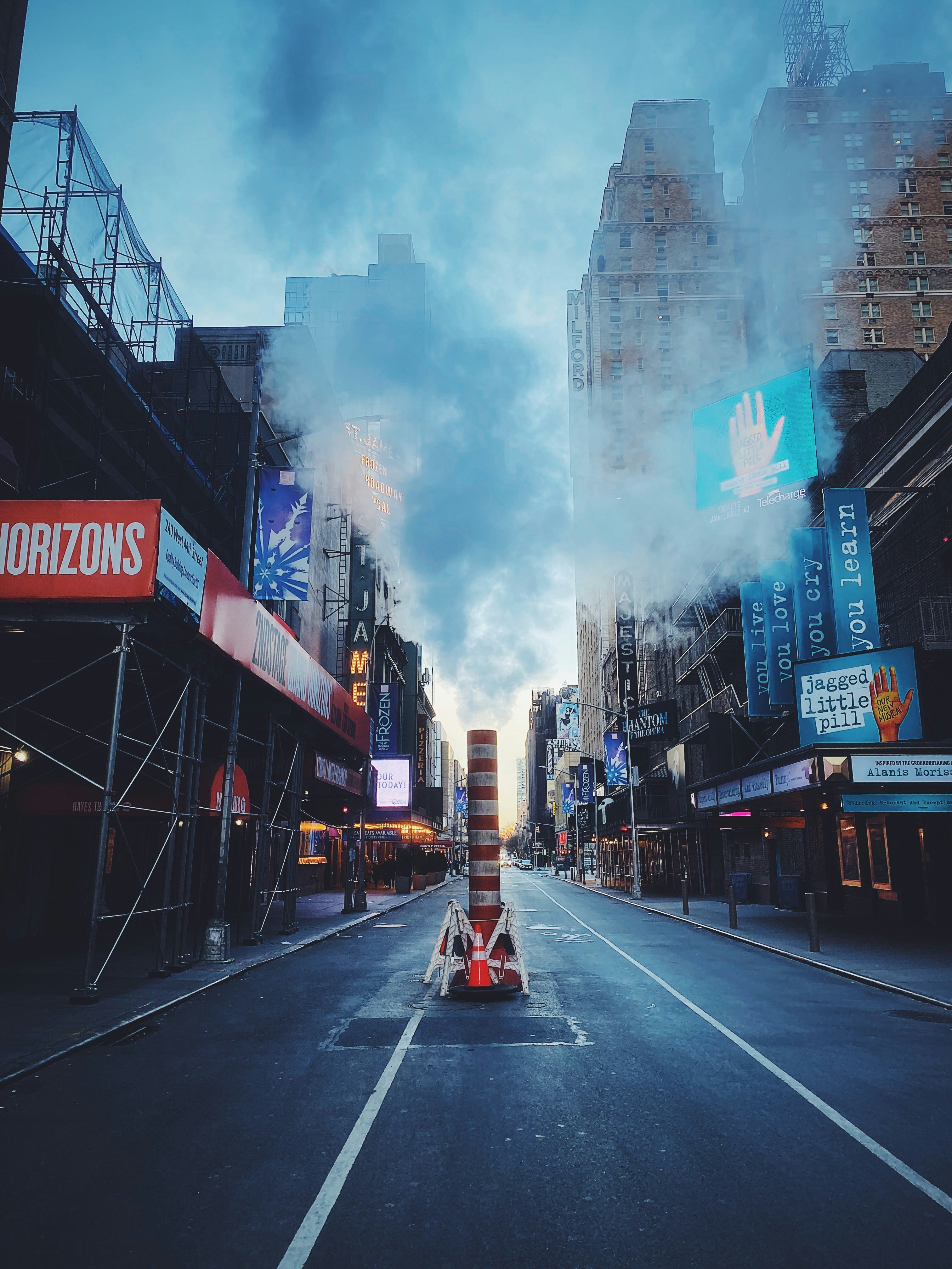 A city street with a lot of tall buildings photo – Free Blue Image on ...
