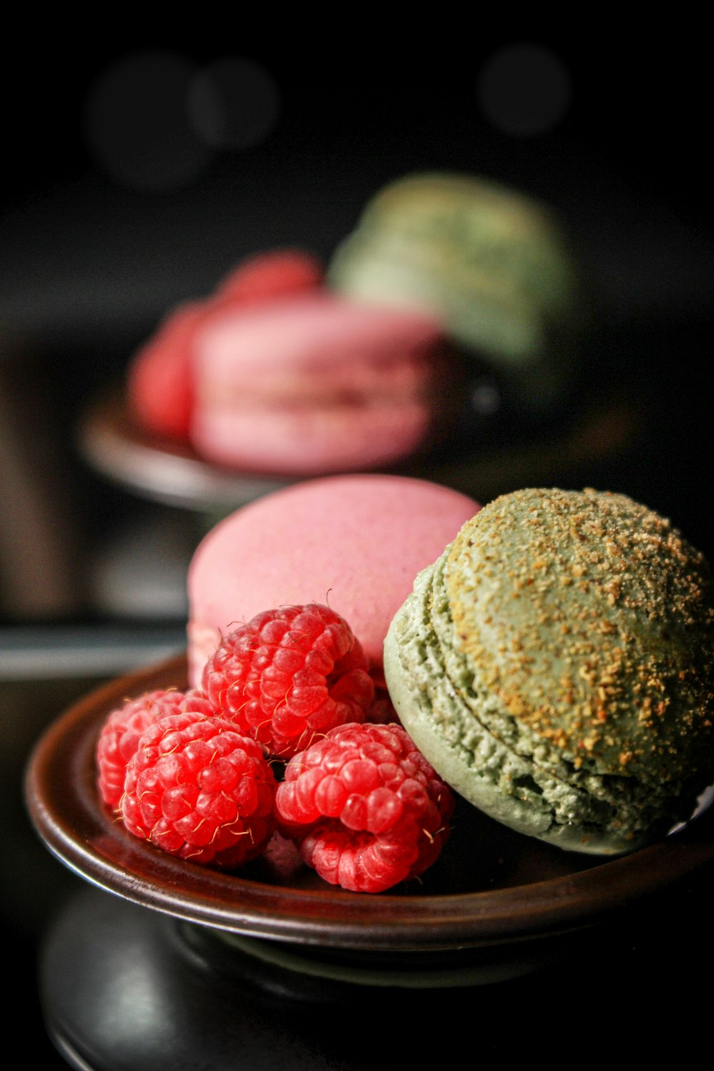 raspberries and French macaroons on plates
