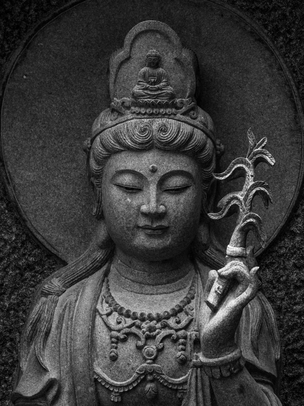 a black and white photo of a buddha statue