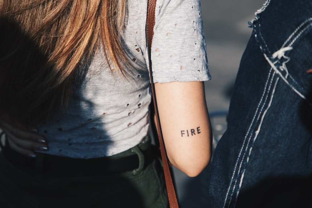 a woman with a tattoo on her arm