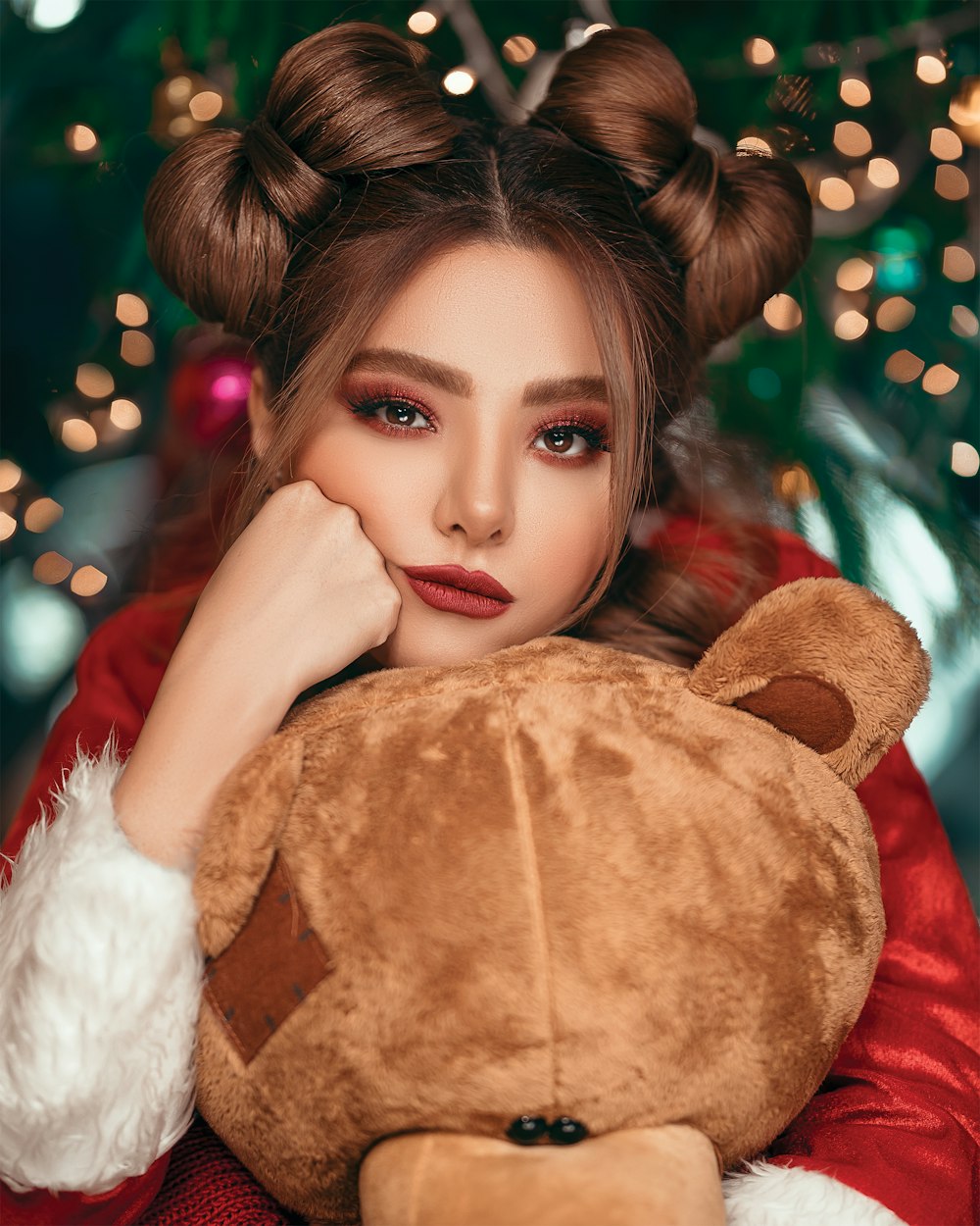 woman holding bear plush toy