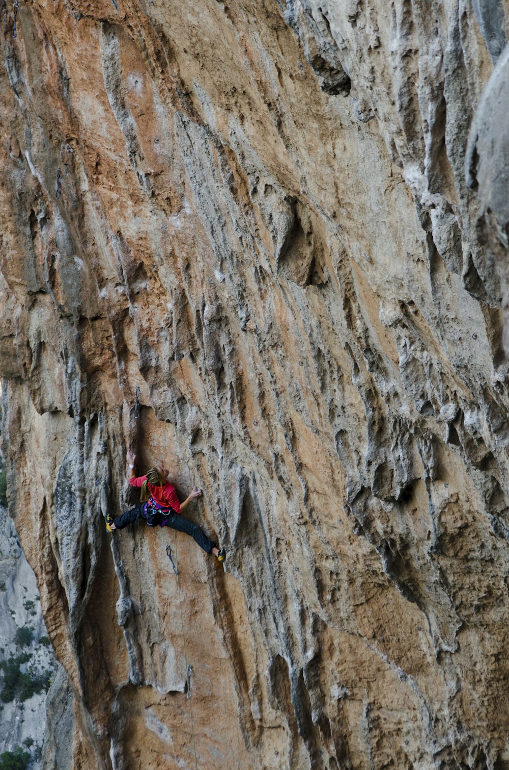 man climbing mountain during day
