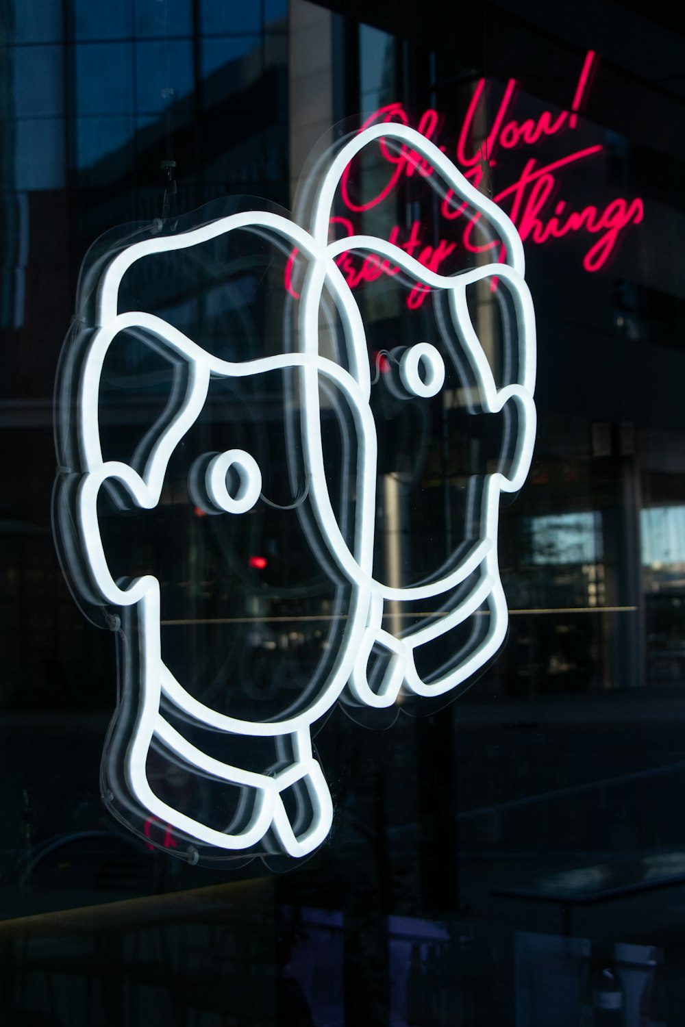 a neon sign in the window of a store