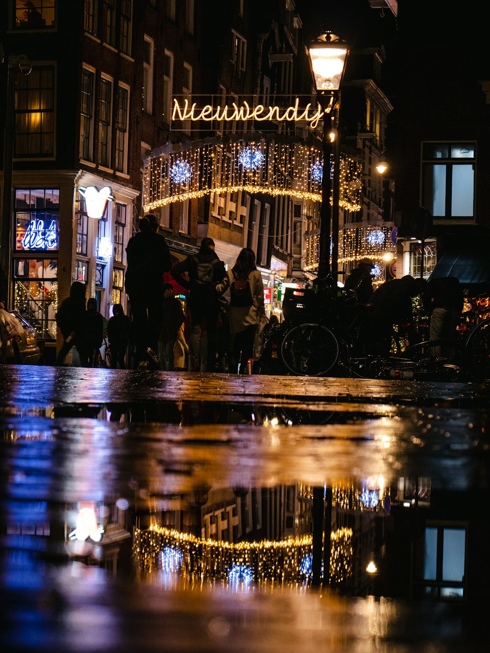 people walking in New Wendy street signage