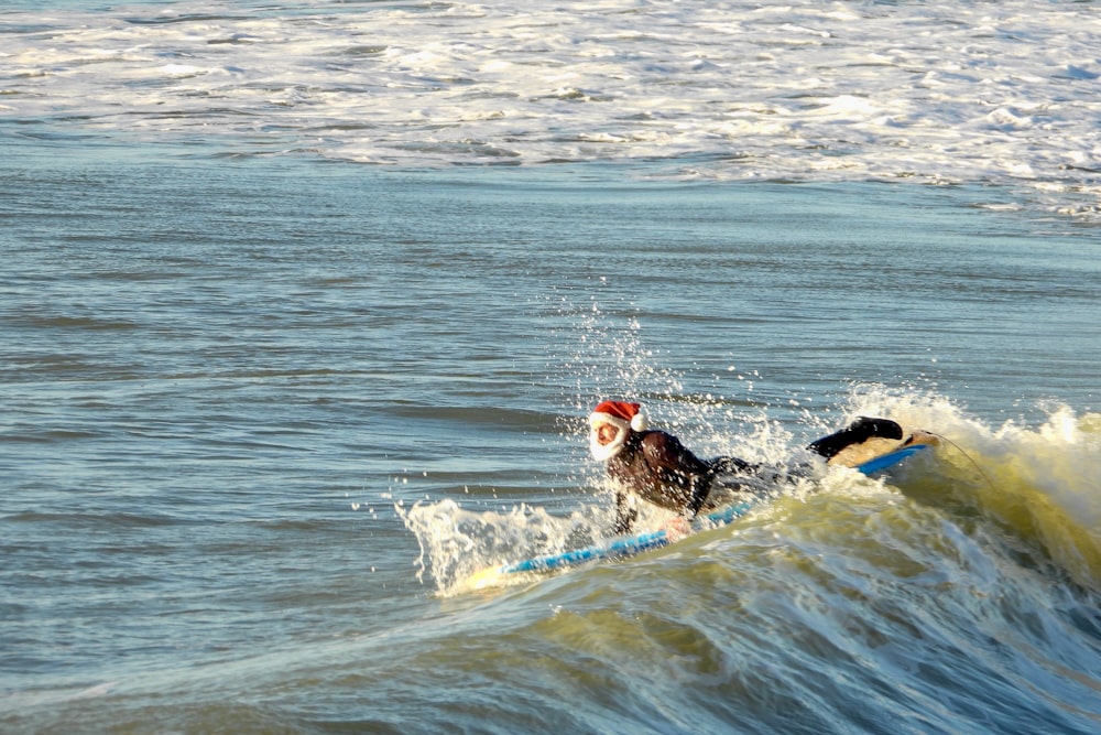 man surfing on sea