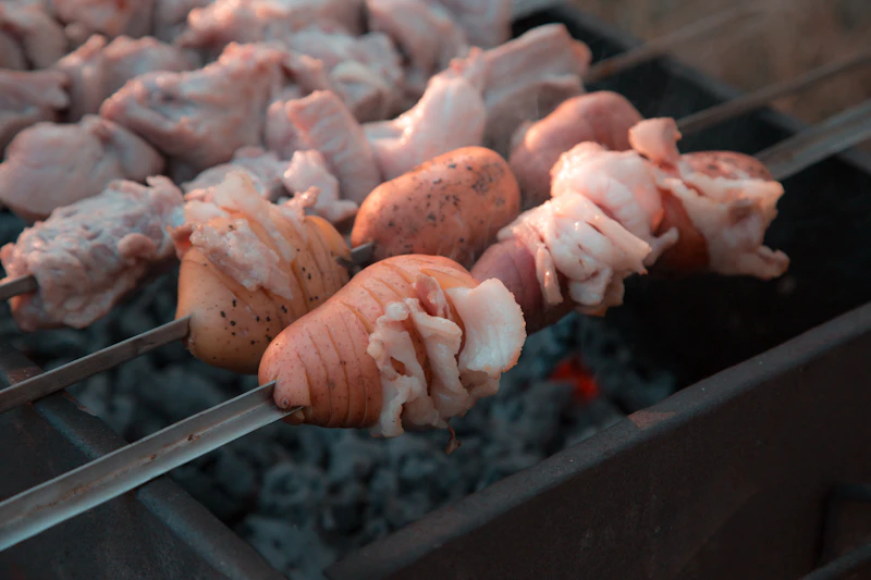 Beef skewers over charcoal grill