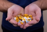 person holding medicine pills