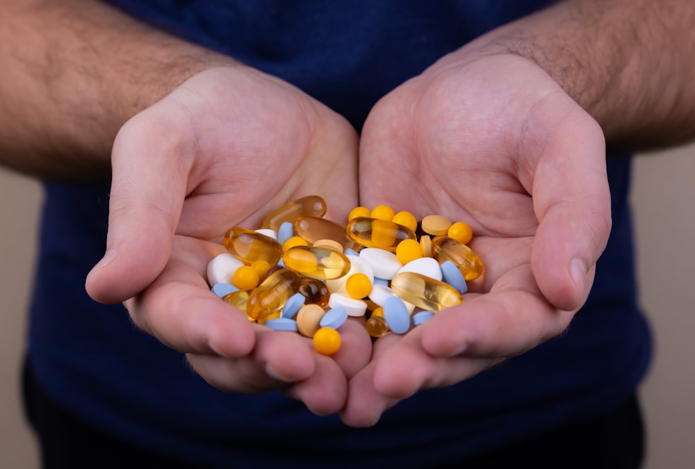 person holding medicine pills