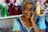 woman in blue and teal top taking selfie indoors