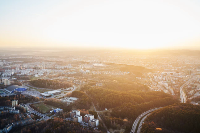 Aerial shot of Bogor cityscape during golden hour with soft sunlight.