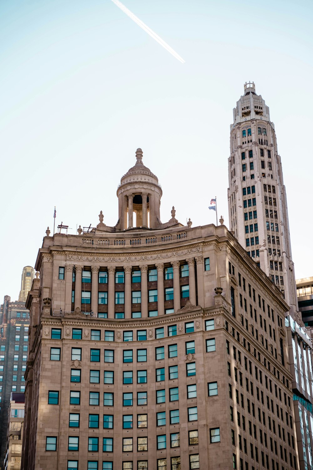 low-angle photography of a brown high-rise building under a calm blue sky during daytime