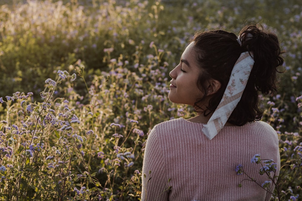 woman in brown sweater facing sideways outdoors