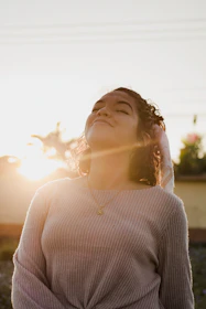 woman in gray sweater looking up